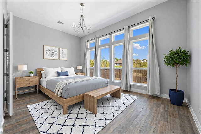 bedroom featuring baseboards, visible vents, a chandelier, and dark wood-style flooring