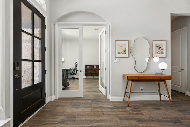 foyer featuring french doors, visible vents, baseboards, and wood finished floors