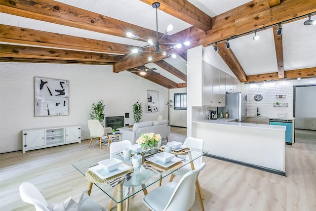 dining space featuring lofted ceiling with beams, ceiling fan, and light wood-style flooring