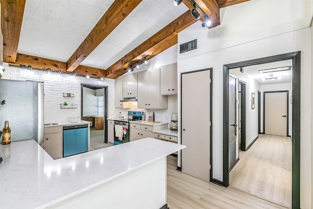 kitchen featuring stainless steel appliances, visible vents, light wood-style floors, light countertops, and beam ceiling