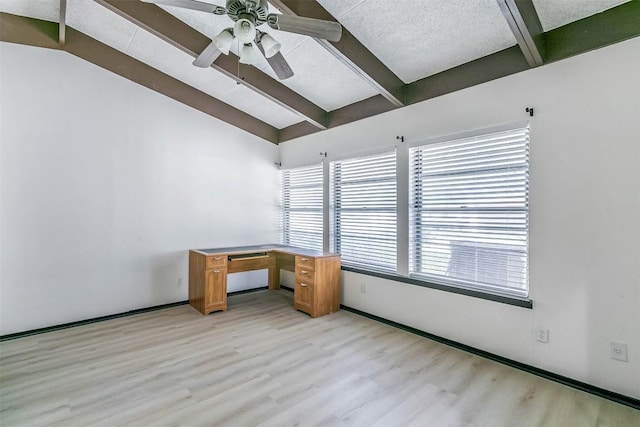 unfurnished office with light wood-style floors, ceiling fan, lofted ceiling with beams, and a textured ceiling