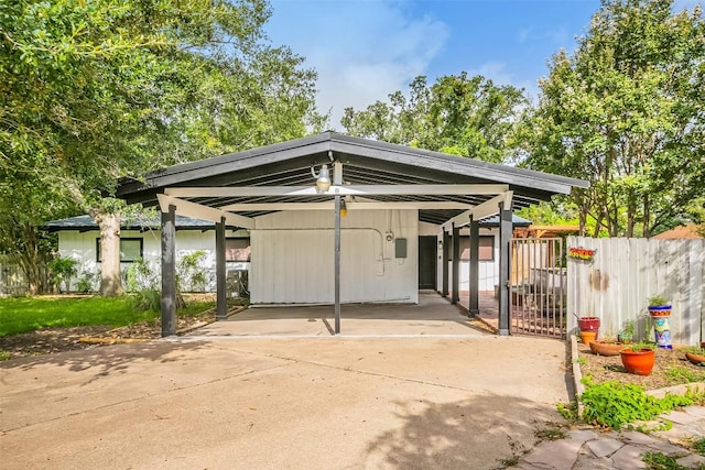 exterior space featuring concrete driveway and fence