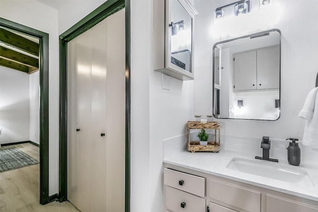 bathroom with wood finished floors and vanity