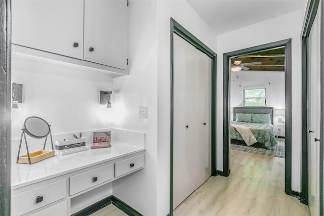 ensuite bathroom with a ceiling fan, ensuite bathroom, and wood finished floors