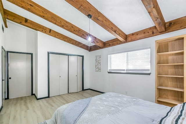 bedroom with lofted ceiling with beams and light wood-style flooring