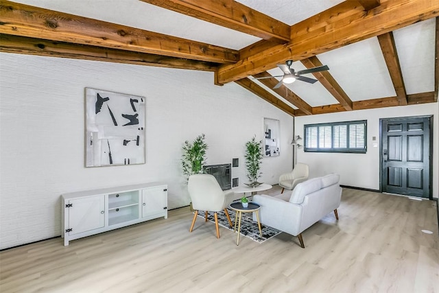 living room with light wood-type flooring, ceiling fan, and lofted ceiling with beams