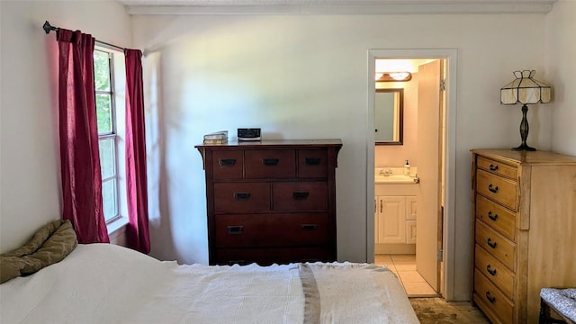 bedroom with a sink and connected bathroom