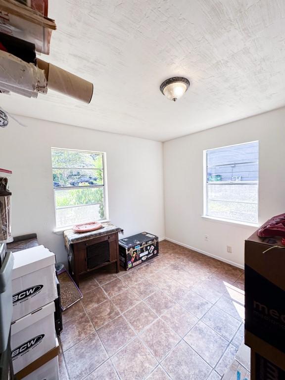 902 Austin Highlands Blvd, Austin, TX 78745 - bedroom with light tile patterned floors and baseboards