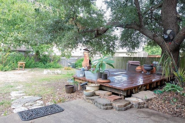 view of yard with a deck and a fenced backyard