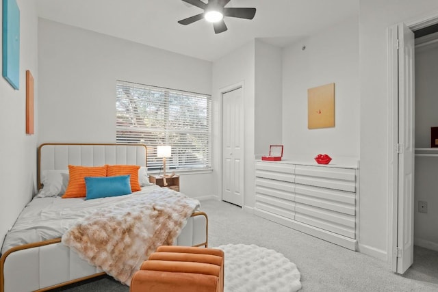 bedroom with light carpet, ceiling fan, and baseboards