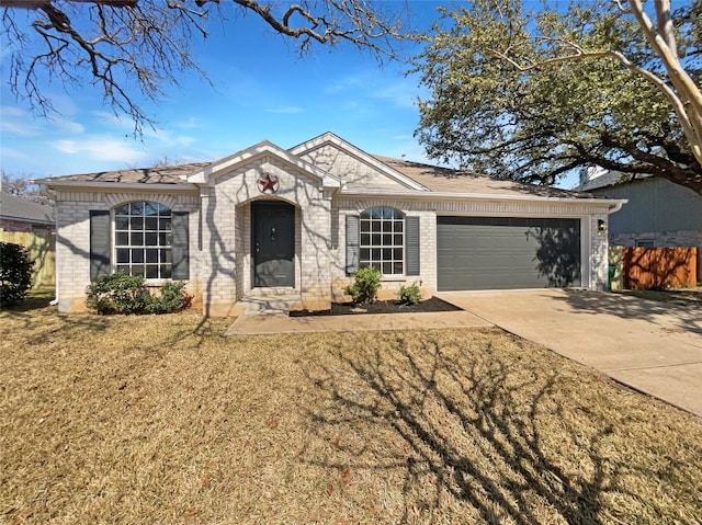 ranch-style home with a garage, driveway, brick siding, and a front yard