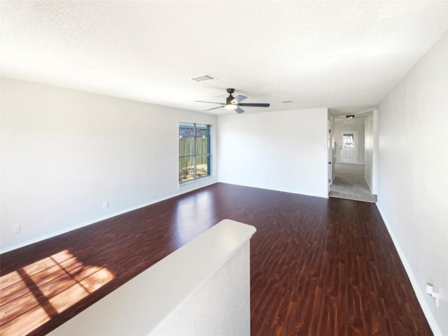 unfurnished room with visible vents, ceiling fan, a textured ceiling, and wood finished floors