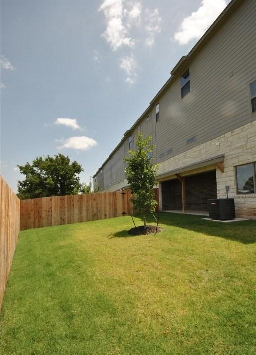 view of yard with cooling unit and a fenced backyard