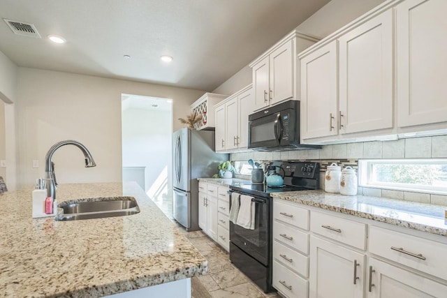 205 Birch Oak Ln, Georgetown, TX 78628 - kitchen featuring a sink, white cabinets, visible vents, black appliances, and decorative backsplash