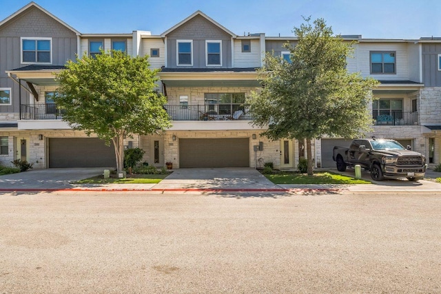 205 Birch Oak Ln, Georgetown, TX 78628 - view of property with a balcony, an attached garage, stone siding, and driveway