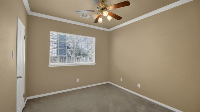 spare room with carpet flooring, ornamental molding, visible vents, and ceiling fan