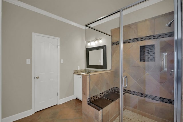 bathroom with crown molding, a shower stall, baseboards, and vanity