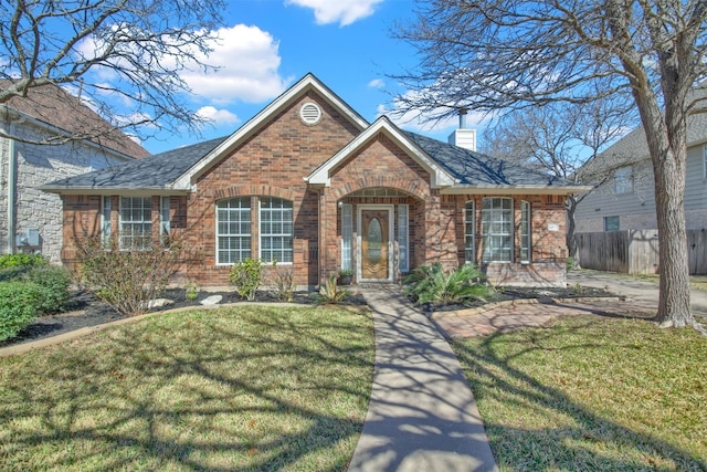 single story home with a chimney, brick siding, a front lawn, and fence