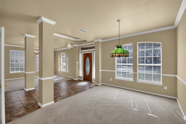 carpeted entrance foyer featuring visible vents, baseboards, ornamental molding, tile patterned floors, and ornate columns