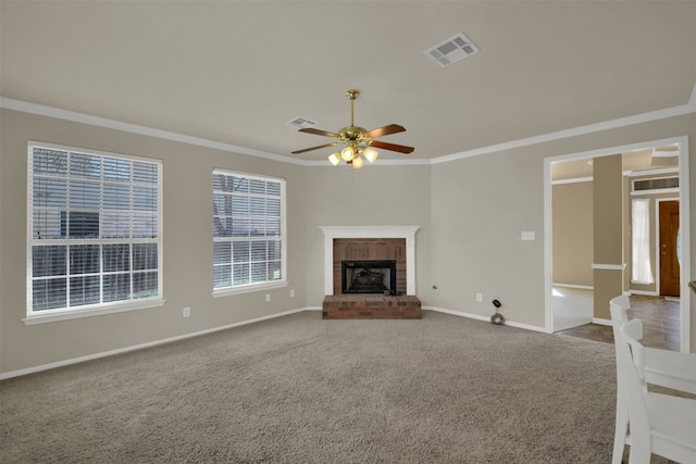 unfurnished living room featuring ornamental molding, visible vents, a fireplace, and carpet flooring