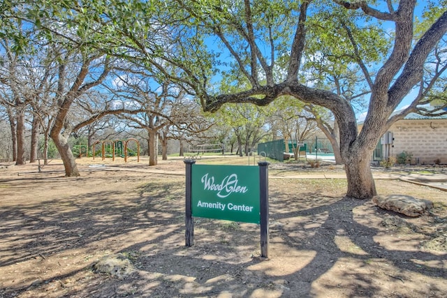 view of home's community featuring fence