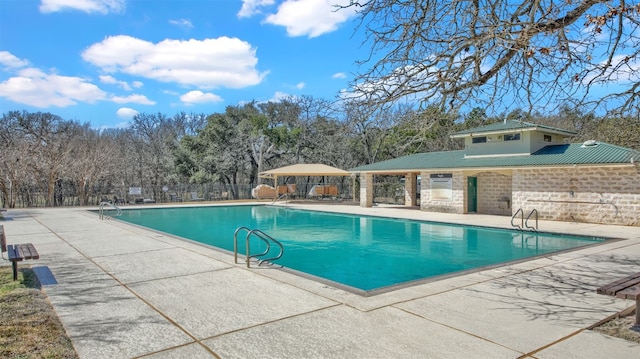pool featuring a patio area and fence