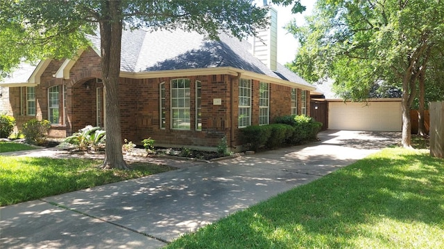 2002 Wood Glen Dr, Round Rock, TX 78681 - view of side of property with brick siding, concrete driveway, a chimney, a garage, and a lawn