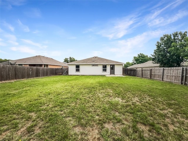12804 Sago Palm Trl, Elgin, TX 78621 - back of house with a fenced backyard
