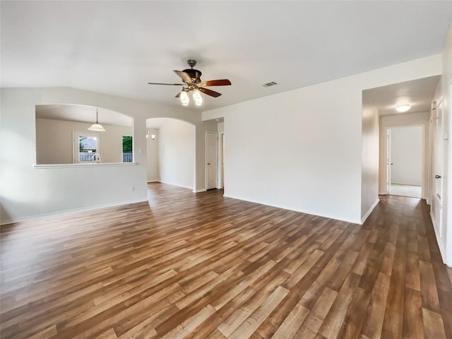 12804 Sago Palm Trl, Elgin, TX 78621 - unfurnished living room featuring ceiling fan, wood finished floors, and arched walkways