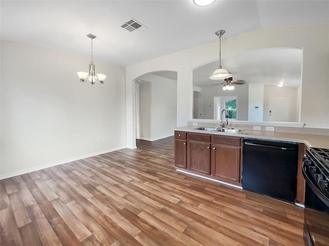 12804 Sago Palm Trl, Elgin, TX 78621 - kitchen with dishwasher, stove, arched walkways, a ceiling fan, and light wood-style floors