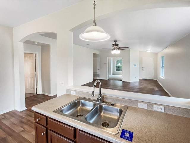 12804 Sago Palm Trl, Elgin, TX 78621 - kitchen featuring arched walkways, ceiling fan, dark wood-style flooring, light countertops, and open floor plan