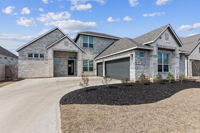 view of front of house featuring a garage, concrete driveway, a shingled roof, and stone siding