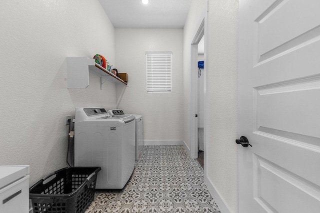 laundry area featuring laundry area, tile patterned flooring, baseboards, and washer and dryer