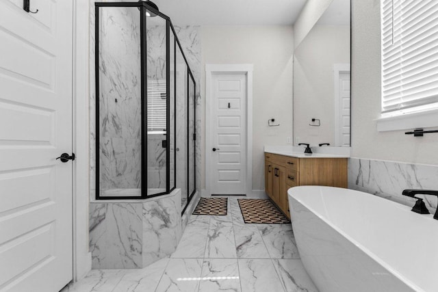 bathroom with marble finish floor, a soaking tub, vanity, and a marble finish shower