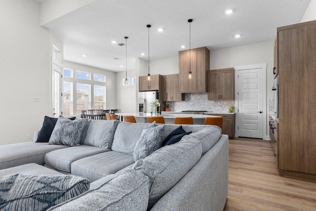 living area featuring recessed lighting and light wood-style floors