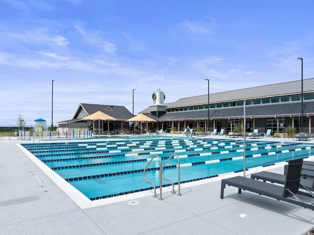 community pool with a patio area