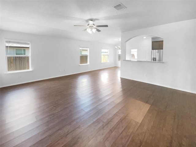 106 Lillian Dr, Taylor, TX 76574 - unfurnished living room with a ceiling fan, dark wood-style flooring, and a chandelier