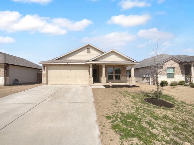 view of front of home featuring driveway, brick siding, a porch, and an attached garage