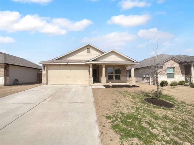 106 Lillian Dr, Taylor, TX 76574 - single story home featuring driveway, a garage, brick siding, and covered porch
