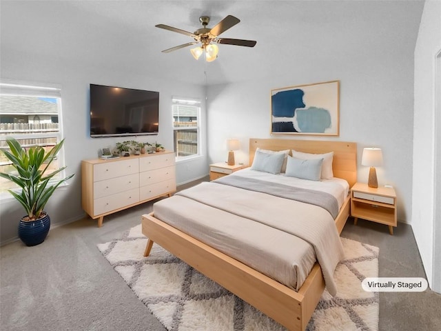 bedroom with a ceiling fan, light carpet, and baseboards