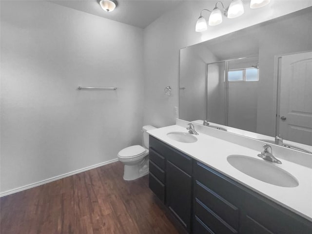 106 Lillian Dr, Taylor, TX 76574 - bathroom with double vanity, a shower with shower door, and wood finished floors