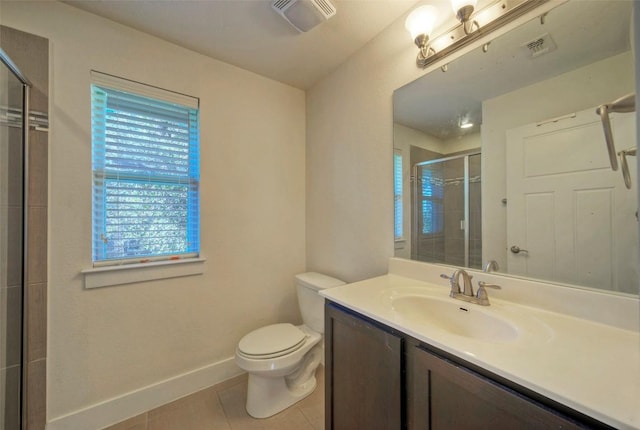 full bathroom featuring tile patterned flooring, toilet, vanity, baseboards, and a stall shower