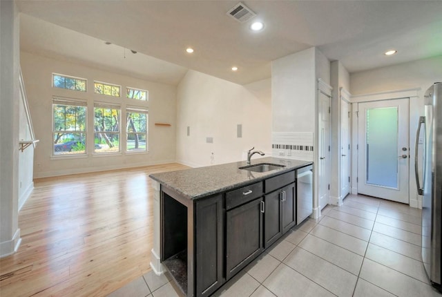 kitchen featuring recessed lighting, visible vents, appliances with stainless steel finishes, a sink, and light stone countertops