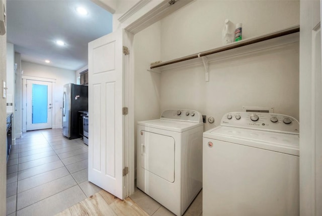 laundry room featuring light tile patterned floors, laundry area, recessed lighting, and washer and dryer