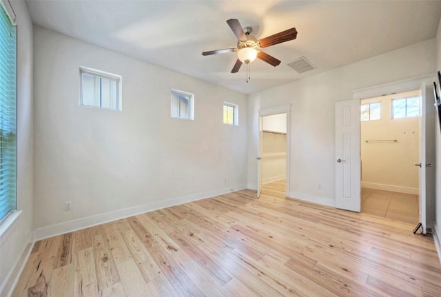 unfurnished bedroom with baseboards, visible vents, and light wood-style floors