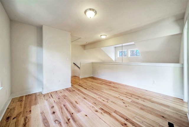 bonus room with wood finished floors and baseboards