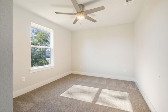 empty room featuring a ceiling fan, carpet, visible vents, and baseboards