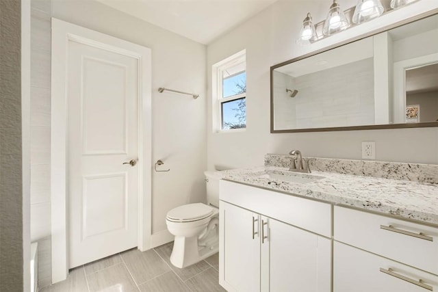 bathroom featuring vanity, walk in shower, and toilet