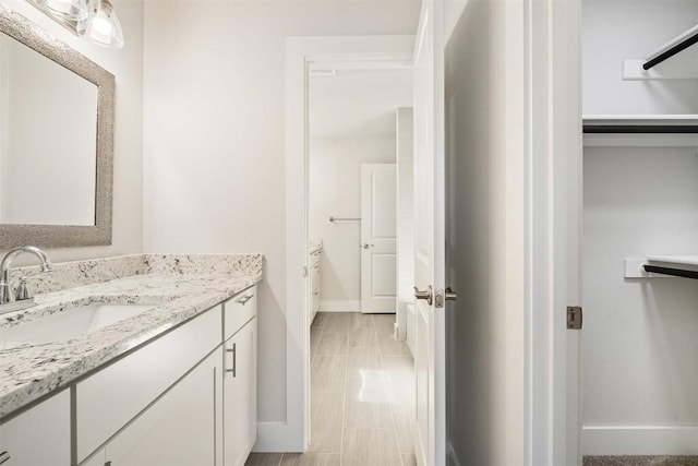 bathroom with vanity and baseboards