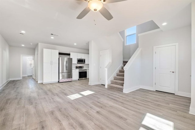 unfurnished living room with recessed lighting, visible vents, baseboards, stairs, and light wood finished floors